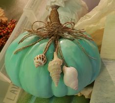 a blue pumpkin with sea shells on it