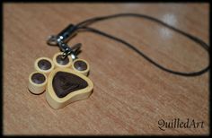 a dog's paw print is attached to a necklace