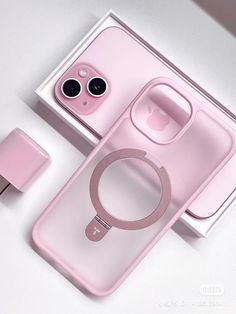 an iphone case with a magnifying glass in the middle and pink packaging next to it