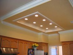 a kitchen with wooden cabinets and lights on the ceiling