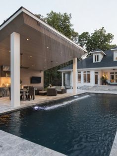 a large pool with a covered patio next to it