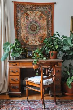 a desk with plants and a tapestry hanging on the wall