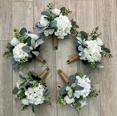 a bunch of flowers arranged in the shape of a wreath on top of a wooden floor