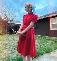 a woman in a red dress holding a baseball bat