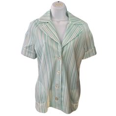 70s mint green and white pinstripe vintage blouse from Henri. Tagged a size 7/8 or a modern medium. Has cute little half round pockets and fun buttons. Very 70s bowling shirt! No stains, tears or rips. Cleaned and stored in a smoke free home. Measurements Shoulders: 16" Sleeves: 9" Bust: 34" Waist: 36" Length: 25" Retro Green Camp Shirt For Spring, Daywear Top With Striped Collar, Green Button-up Shirt With Striped Collar, Vintage Green Blouse With Relaxed Fit, Retro Green Button-up Top, Striped Collared Blouse, Green Collared Top For Daywear, Retro Green Button-up Blouse, Vintage Striped Collared Tops