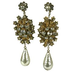 Long Miriam Haskell signature faux baroque teardrop pearl and Russian gilt oval snowflake filigree ear clips. The oval filigree enhanced by a center crystal rhinestone flower head and set with crystal rhinestones on the surrounding spokes. Hand sewn faux baroque pearl and crystal rose montees decorate the earrings flower top motif. Clip back Fittings. Excellent Condition, Signed. Length 3.25" x Width 1" Ear Clips, Flower Top, Miriam Haskell, Earrings Flower, Rhinestone Flower, Crystal Rose, Flower Tops, Pearl Earrings Dangle, Tahitian Pearls