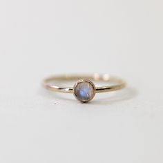 This ring features a 5mm rose cut  Rainbow Moonstone stone set on a delicate 14/20 gold filled band. This ring is great on its own, or stacked with our other designs.  Made from 14/20 gold-filled wire, it is water-resistant and will be a piece that lasts. Each piece is custom-made for you, so please allow 1-5 days for the jewelry to ship. - 14/20 Gold Filled  - 1.5mm band - 5mm stone - Handmade to order - Comes neatly packaged in a kraft jewelry box ready for gifting Delicate 14k Gold Filled Stackable Promise Rings, Dainty 14k Gold-filled Stackable Promise Rings, Stackable Rose Gold Crystal Ring In 14k Gold, Stackable Crystal Ring In 14k Rose Gold, Rose Gold Stackable Crystal Ring In 14k Gold, Stackable 14k Rose Gold Crystal Ring, Dainty Stackable Moonstone Jewelry, Delicate 14k Gold Filled Midi Rings, Gold Stackable Moonstone Gemstone Rings