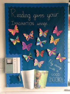 a bulletin board with colorful butterflies on it and a book about reading gives your imagination wings