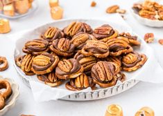 a plate full of pecans sitting on a table next to other plates and bowls