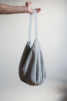 A minimalist linen bucket bag. You can choose other colors and quantities in the drop down menu when purchasing.The Quiet Objects bucket bag is a minimalist piece that is suitable for so many things. Made from linen it is a medium size bag for packing groceries, packing your most needed beach accessories or any day items when strolling in the city. It is a minimal piece with a single 32cm strap in the middle, just the right size for convenient shoulder carrying. The inside is natural cotton. The Linen Hobo Tote Bag For Daily Use, Handmade Cotton Hobo Bag For Everyday Use, Cotton Bucket Bag For Vacation, Linen Tote Canvas Bag For Beach, Summer Cotton Bucket Bag With Adjustable Strap, Summer Bucket Bag With Adjustable Strap In Cotton, Handmade Linen Bags For Everyday Use, Cotton Tote Bucket Bag For Beach, Cotton Beach Tote Bucket Bag