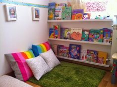 a child's room with bookshelves and green carpet