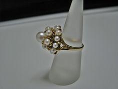 "For Sale is: (1) H077 Stunning Coctail (19) Pearl Ring in 14k Yellow Gold Please Read ENTIRE DESCRIPTION BEFORE PURCHASING This beautiful ring features cocktail ring with multiple (19) pearls in different size. Ring stamped 14k and it is size 5.5 This is a very elegant ring! Cosmetic Condition: This ring is in good condition. A few minor scratches due to age. AS SEEN IN PICTURE: Specifications: *14K Yellow Gold *Cocktail Style *Pearls (12) are approx. 3.4 mm (at the bottom of the ring) *Pearls Classic 14k Gold Pearl Ring Hallmarked, Antique Hallmarked Pearl Ring For Formal Occasions, Luxury 14k Gold Hallmarked Pearl Ring, Antique Yellow Gold 14k Pearl Ring, Pearl Cocktail Ring, Gold Cocktail, Filigree Ring, Elegant Ring, Wristwatch Men