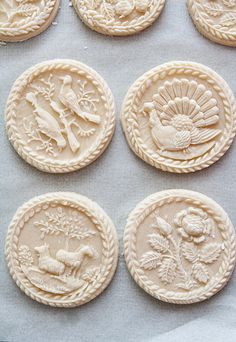 some cookies that have been decorated with different designs on them and are sitting on a baking sheet