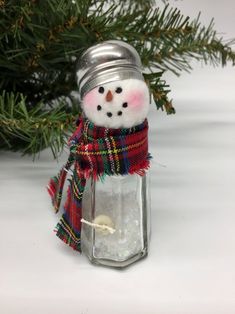 a glass jar with a snowman in it