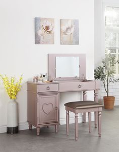 a pink vanity and stool in a room