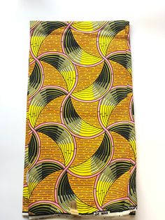 a yellow and black pattern on a piece of cloth