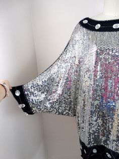 "This beautiful vintage piece fully embellished with reflective mirror silver sequins and jewels on silk and fully lined. It's in excellent condition! (note, I was wearing a pink shirt while photographing and the color reflects in the sequins) Bust - 58\" Waist - 44\" Hips - 42\" Length - 34\" All of my items come from a smoke-free and pet-free home. If you have any questions, please don't hesitate to ask!" Oversized Tunic Dress, Sequined Mini Dress, Iridescent Dress, Checkered Jacket, Mirror Silver, Oversized Tunic, Mini Dress Black, Sequin Mini Dress, Silver Sequin