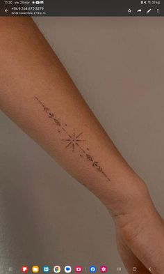 a person's arm with a small star tattoo on the left side of their arm