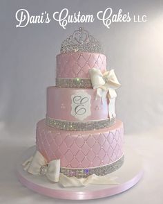 a three tiered pink cake with white bows and tiara on top that says dana's custom cakes, inc