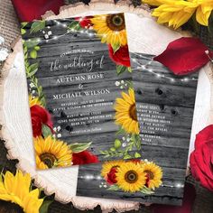 two sunflowers and red roses are on top of a rustic wood background with string lights