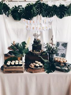 a table topped with lots of cakes and desserts