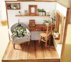 a doll house with a desk and chair in the living room, as well as potted plants