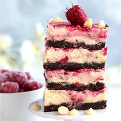 a piece of cake sitting on top of a white plate next to raspberries