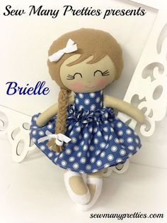 the doll is wearing a blue dress with white polka dots on it's skirt