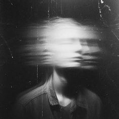 a blurry image of a man's face in the middle of an abstract photo