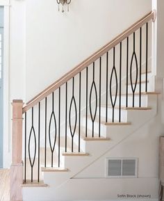 a white staircase with black iron railing and wood handrails in a home setting