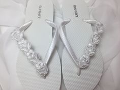 These beautiful white flip flops are wrapped with white satin ribbon, and adorned with a white Bridal flower trim with seed bead and sequins. Ribbon color is white, if you are needing other colors of ribbon or decoration please contact me and will be happy to accommodate you! All flip flops are handmade to order and the production time is 3 to 5 days, then please allow additional time for shipping. Amazing for beach, weddings, flower girl or a fancy event, you choose! Please choose your size fro Blush Champagne Wedding, Beach Wedding Flip Flops, Flip Flops Wedding, Bridesmaid Flip Flops, White Bridal Flowers, Girls Wedding Shoes, Bridal Flip Flops, Beach Wedding Sandals, Wedding Flip Flops