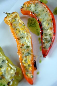 three stuffed peppers on a plate with broccoli florets and cheese toppings