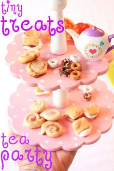 there is a pink cake stand with donuts and tea cups on it that says tiny treats tea party