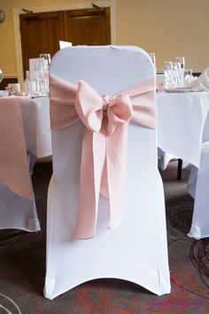 the back of a chair with a pink bow on it