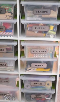 organized storage bins with labels and stickers on the lids for crafting supplies