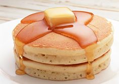 a stack of pancakes with syrup and butter on top