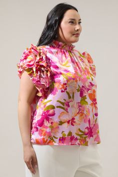 Show off your effortlessly sweet style in the Abigal Floral Brenna Mock Neck Ruffle Blouse! Our favorite blouse takes shape featuring a smocked, mock neck. Ruffle layered short sleeves steal the show while framing a relaxed bodice that can be styled tucked into your favorite high waisted bottoms.- Mock neck- Ruffle layer sleeves- Keyhole- Classic fit- Color: Coral MultiSize + Fit - Model is 5'10" and wearing size 2X- Measurements taken from size 2X - Chest: 49 1/2"- Length: 26 1/2" Fabric Self: Feminine Top With Smocked Bodice And Flutter Sleeves, Spring Chic Blouse With Elastic Neckline, Feminine Tops With Smocked Bodice And Flutter Sleeves, Chic Spring Blouse With Elastic Neckline, Chic Elastic Neckline Blouse For Spring, Spring Daywear Blouse With Flutter Sleeves, Feminine Smocked Top With Ruffles For Spring, Feminine Top With Smocked Back And Flutter Sleeves, Spring Feminine Blouse With Elastic Neckline