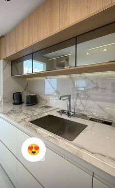 a kitchen with marble counter tops and wooden cabinets