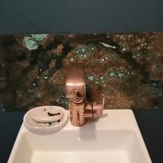 a bathroom sink with a faucet and soap dispenser on it