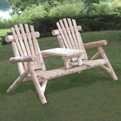 a wooden chair sitting on top of a lush green field