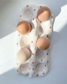 an egg tray with four eggs in it