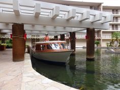 a boat is docked in the water under an overpass at a resort or hotel