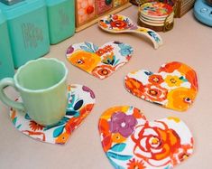 colorful heart shaped coasters and cups on a table