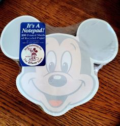 a mickey mouse shaped paper plate on top of a wooden table