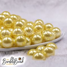 a white plate filled with yellow pearls