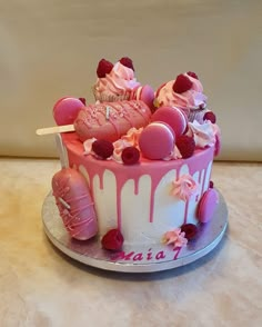 a pink and white cake with lots of frosting