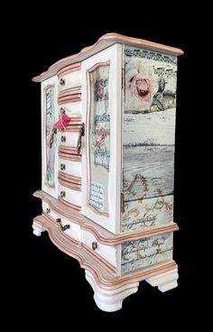 an ornate white and pink chest with roses on the front, decorated with words and pictures