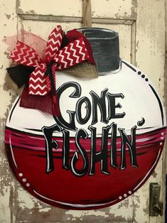 a red and white sign that says gone fishin with a hat on it's head