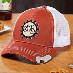 a red and white trucker hat with an image of a bicycle on it