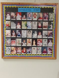 a wooden frame with pictures on it hanging from the wall in front of a white wall